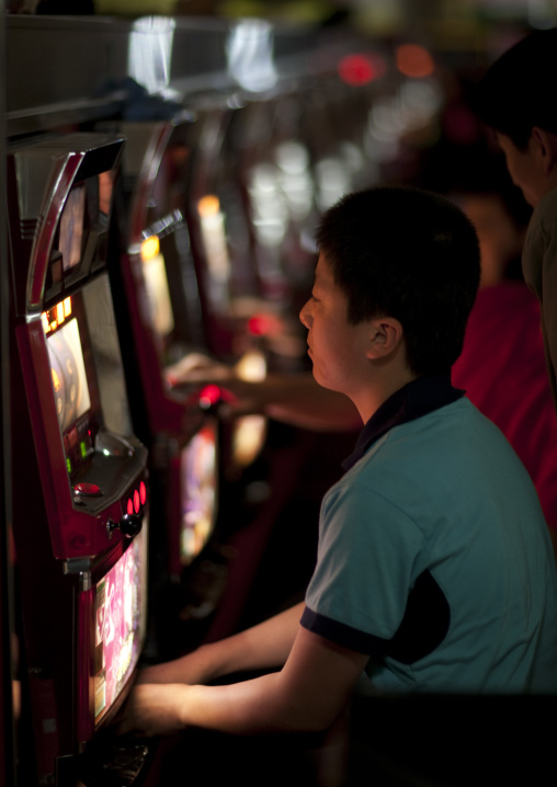 North Korean people playing slot machines in a casino, Pyongan Province, Pyongyang, North Korea