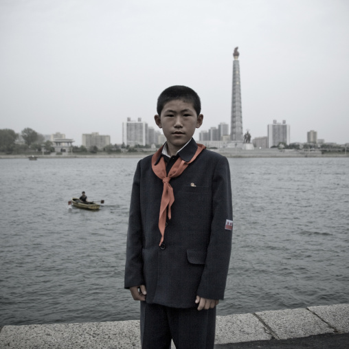 Young North Korean pioneer posing in front of the Juche tower
, Pyongan Province, Pyongyang, North Korea