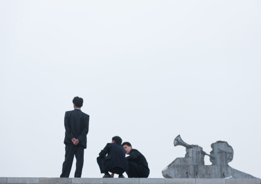 North Korean young men in black suits in Kim il Sung square, Pyongan Province, Pyongyang, North Korea