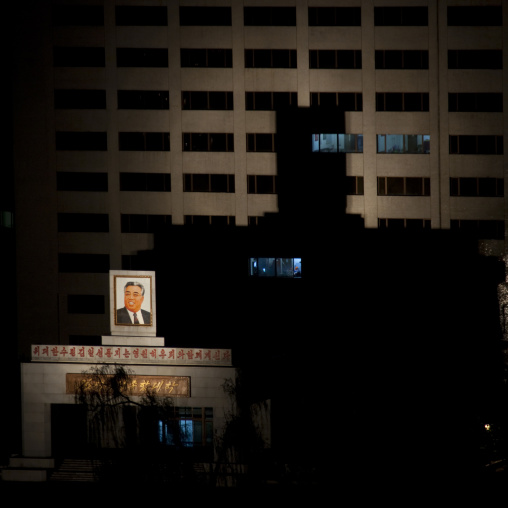 Portrait of Kim jung il enlightened on a building in the night, Pyongan Province, Pyongyang, North Korea
