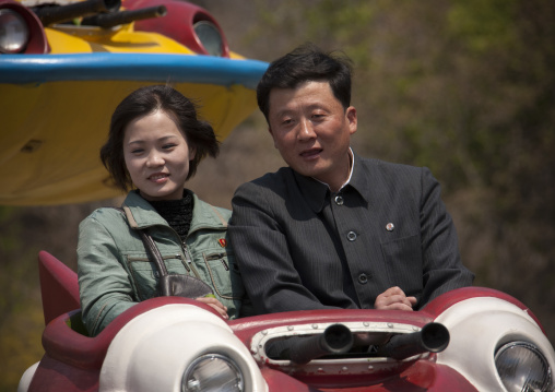 North Korean couple having fun on a flying saucer attraction in Taesongsan funfair, Pyongan Province, Pyongyang, North Korea