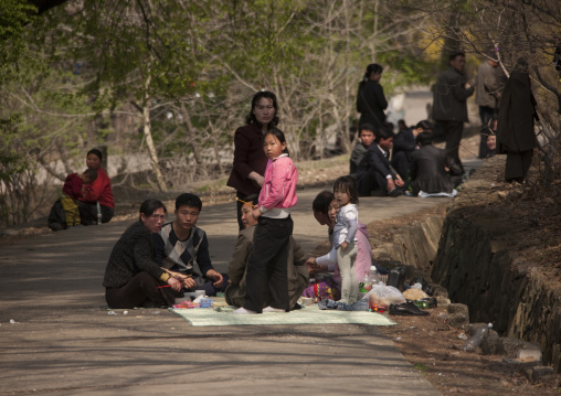 North Korean family having a picnic on a road leading to a park, Pyongan Province, Pyongyang, North Korea