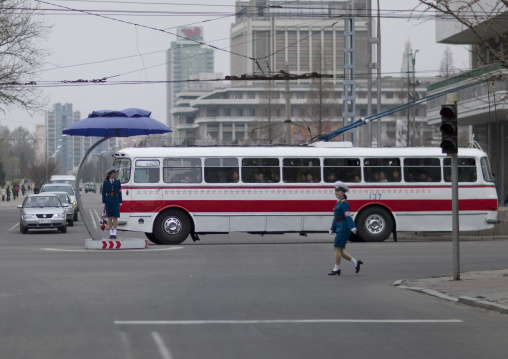 North Korean female traffic security officers in blue uniforms in a busy street, Pyongan Province, Pyongyang, North Korea