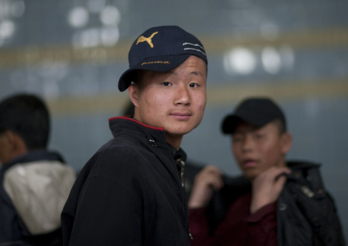 North Korean teenage boy with a puma cap in a subway station, Pyongan Province, Pyongyang, North Korea
