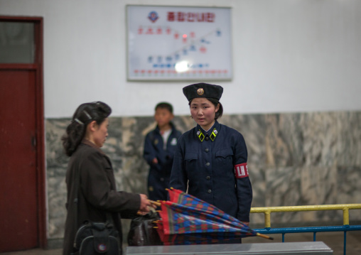 North Korean subway employee in front of a tickets machine, Pyongan Province, Pyongyang, North Korea
