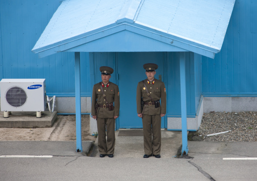 North Korean soldiers standing in front of the United Nations conference rooms on the demarcation line in the Demilitarized Zone, North Hwanghae Province, Panmunjom, North Korea