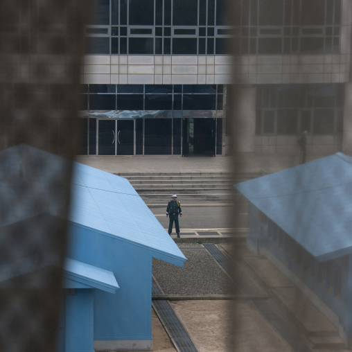 North Korean soldier standing in front of the United Nations conference rooms on the demarcation line in the Demilitarized Zone, North Hwanghae Province, Panmunjom, North Korea