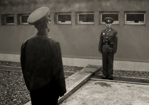 North Korean soldiers standing in front of the United Nations conference rooms on the demarcation line in the Demilitarized Zone, North Hwanghae Province, Panmunjom, North Korea