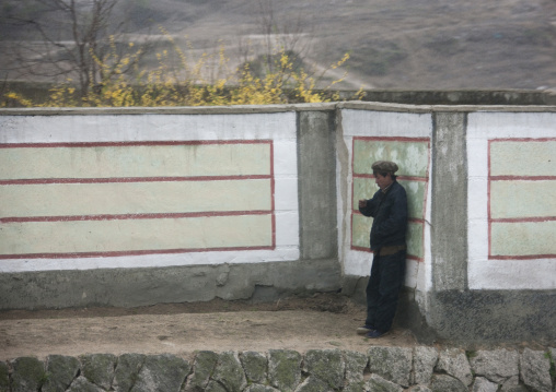 North Korean man leaning on a wall, North Hwanghae Province, Kaesong, North Korea