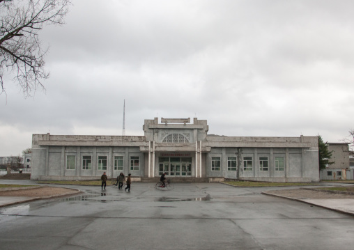 North Korean people passing in front of an old stadium, North Hwanghae Province, Kaesong, North Korea