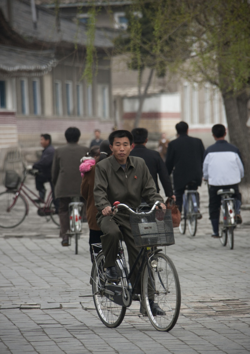 North Korean cyclists in the street, North Hwanghae Province, Kaesong, North Korea