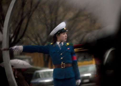 North Korean traffic security officer in blue uniform in the street, Pyongan Province, Pyongyang, North Korea
