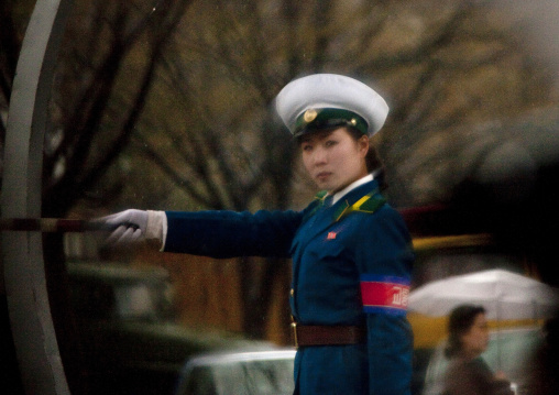 North Korean traffic security officer in blue uniform in the street, Pyongan Province, Pyongyang, North Korea
