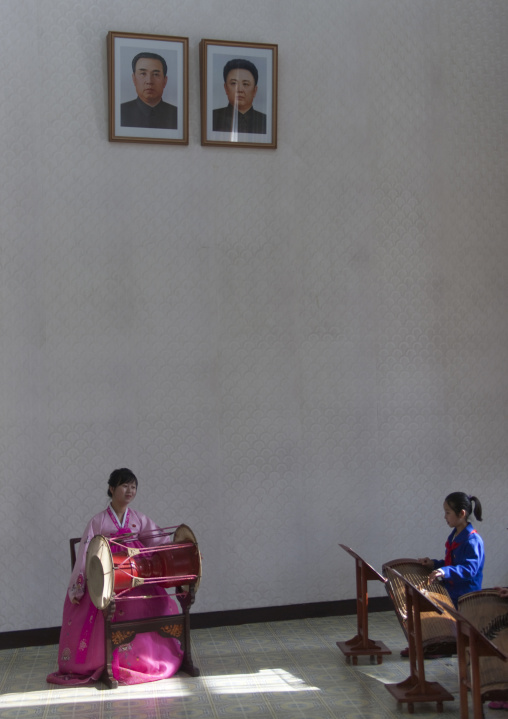 Music lesson at Mangyongdae children's palace under the official portraits of the Dear Leaders, Pyongan Province, Pyongyang, North Korea
