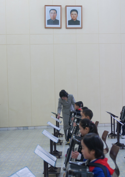 Accordion class in Mangyongdae children's palace under the portraits of the Dear Leaders, Pyongan Province, Pyongyang, North Korea