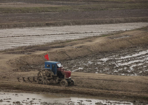 Old North Korean tractor in a field in the countryside, Pyongan Province, Pyongyang, North Korea