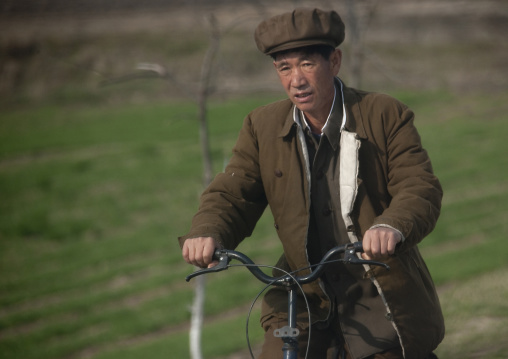 North Korean man riding a bicycle, Kangwon Province, Wonsan, North Korea