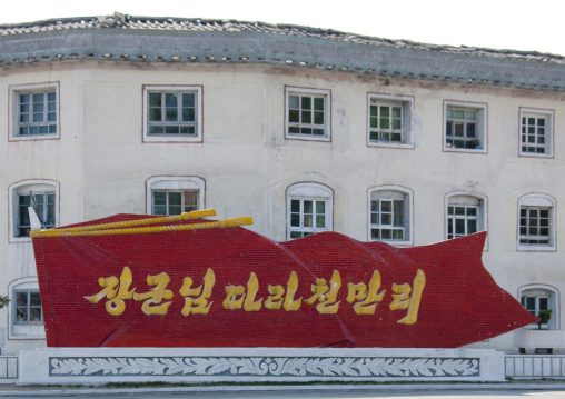 Propaganda slogan on a red billboard in town, Kangwon Province, Wonsan, North Korea