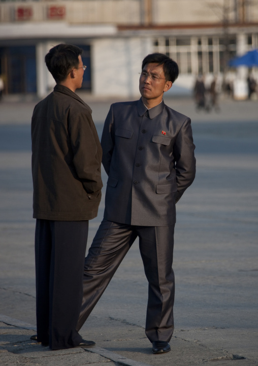 North Korean men dressing with vinylon suits chatting in the street, Kangwon Province, Wonsan, North Korea