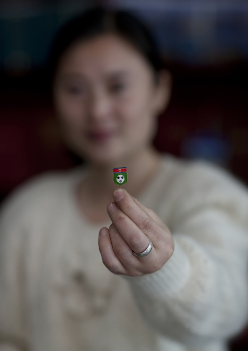 North Korean woman showing a football pin, Ryanggang Province, Samjiyon, North Korea