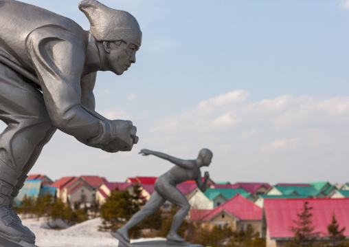 Statue of a ice skaters in front of new apartment houses, Ryanggang Province, Samjiyon, North Korea