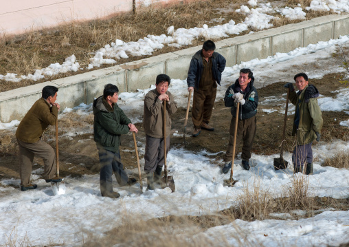 North Korean men removing snow in the street, Ryanggang Province, Samjiyon, North Korea