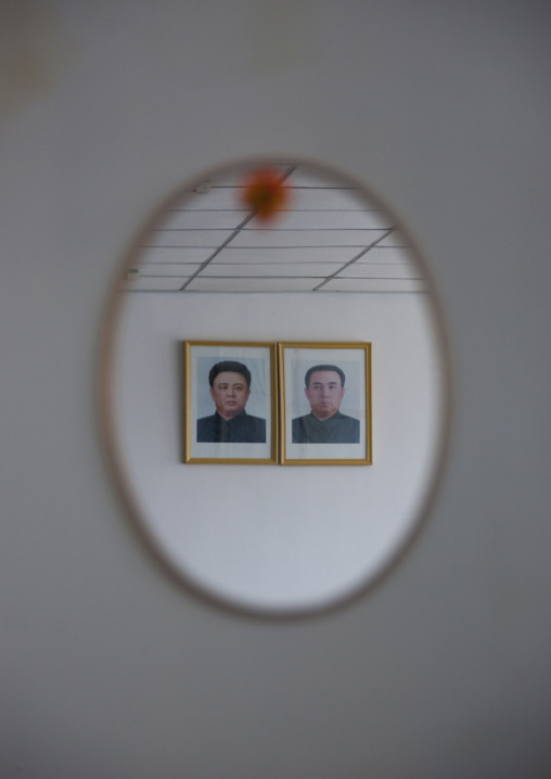 Two presidents portraits reflection in a mirror in Samjiyon children's palace, Ryanggang Province, Samjiyon, North Korea