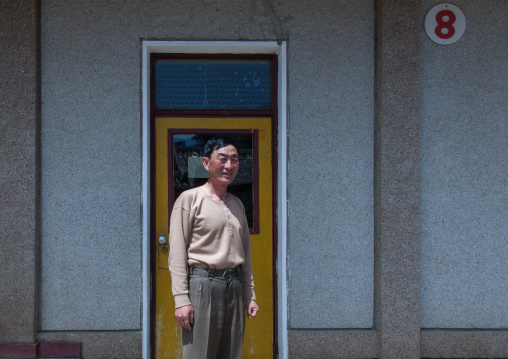 North Korean man in front of his house in a village, North Hamgyong Province, Jung Pyong Ri, North Korea