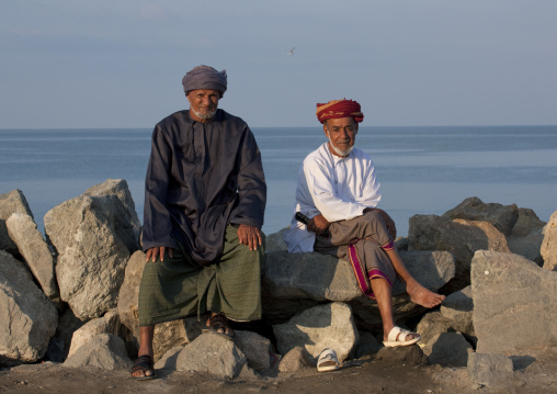 Men Sitting On The Rocks In Masirah Island, Oman