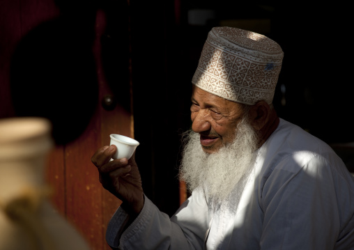 Old Omani Man In Nishdasha Holding A Cup, Oman