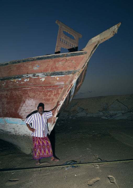 Man Standing Beside The Dhow In Masirah Island, Oman