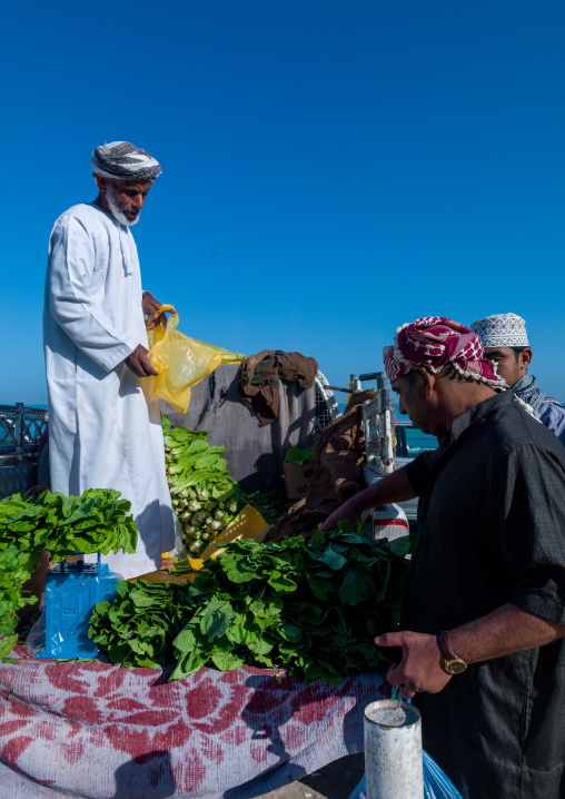 Old mani man selling vegetables on the back of his car, Al Batinah, Barka, Oman