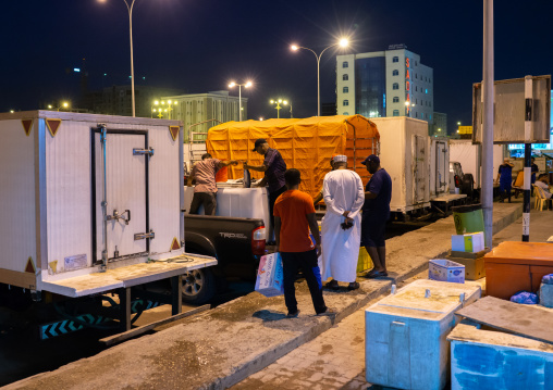 Cars delivering fresh fish in the night market, Dhofar Governorate, Salalah, Oman