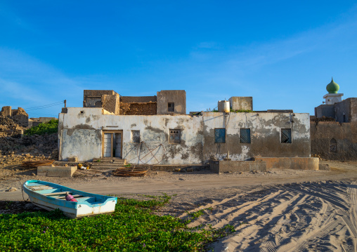 Fisherman boat in front of an old house, Dhofar Governorate, Mirbat, Oman