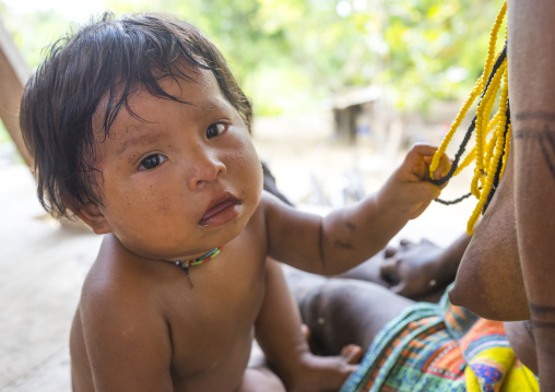 Panama, Darien Province, Bajo Chiquito, Embera Tribe Baby Playing With Necklaces