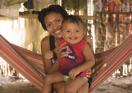 Panama, San Blas Islands, Mamitupu, Portrait Of A Smiling Kuna Tribe Mother With Her Baby In A Hammock