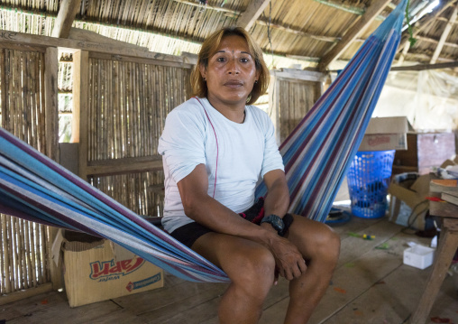 Panama, San Blas Islands, Mamitupu, Gay Kuna Indigenous Man Sitting In A Hammock