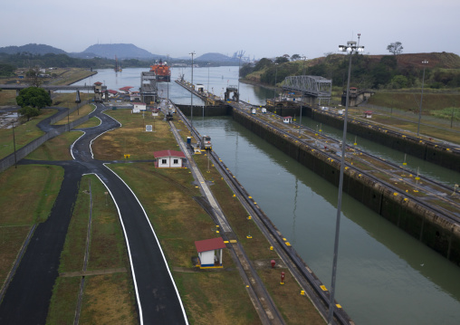 Panama, Province Of Panama, Panama City, Container Ship Passing Through The Miraflores Locks In The Panama Canal