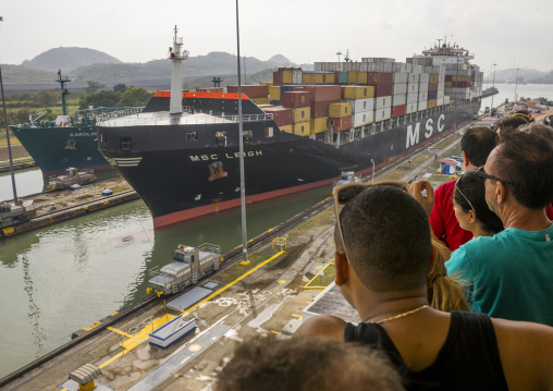 Panama, Province Of Panama, Panama City, Tourists Watching Container Ship Passing Through The Miraflores Locks In The Panama Canal