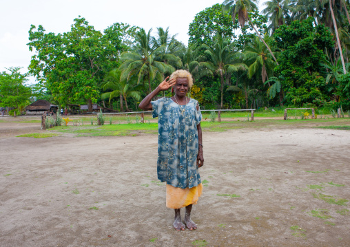 Old woman with pollens in her blonde hair, New Ireland Province, Langania, Papua New Guinea