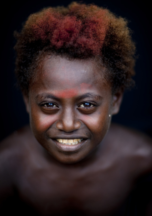 Portraot of a smiling boy with traditional makeup, New Ireland Province, Langania, Papua New Guinea