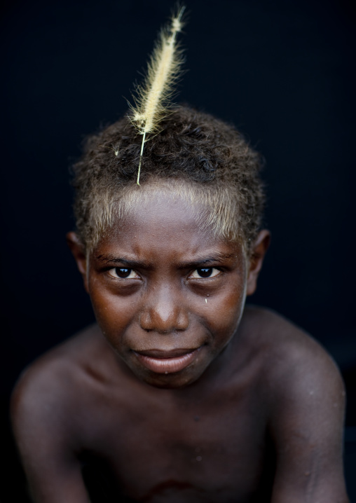 Portrait of a boy with a feather in the hair, New Ireland Province, Langania, Papua New Guinea