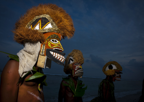 Malagan tatuana masks dance during a funeral ceremony, New Ireland Province, Langania, Papua New Guinea