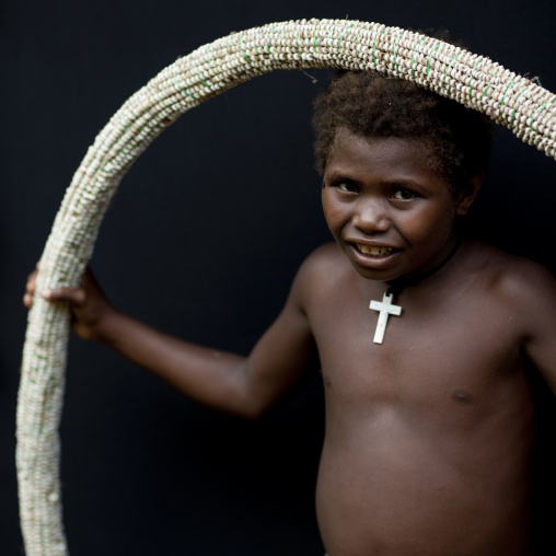 Girl holding a giant shell money, East New Britain Province, Rabaul, Papua New Guinea