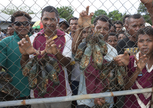 Crowd at the airport waiting for the plane arrival, Milne Bay Province, Trobriand Island, Papua New Guinea