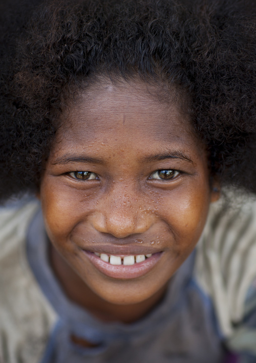 Portrait of a young girl smiling, Milne Bay Province, Trobriand Island, Papua New Guinea