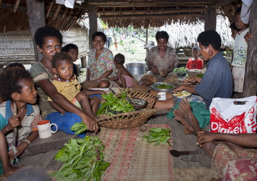 Women making food inside a house, Milne Bay Province, Trobriand Island, Papua New Guinea