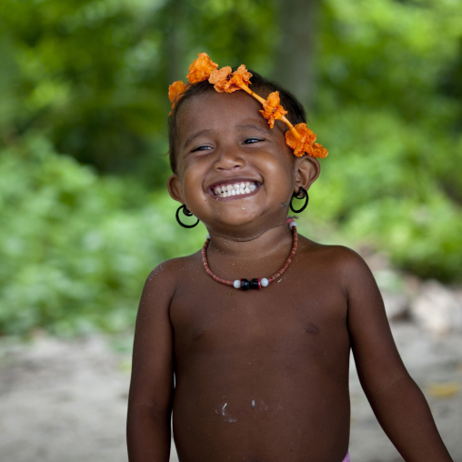 Smiling girl with flowers in the hair, Milne Bay Province, Trobriand Island, Papua New Guinea