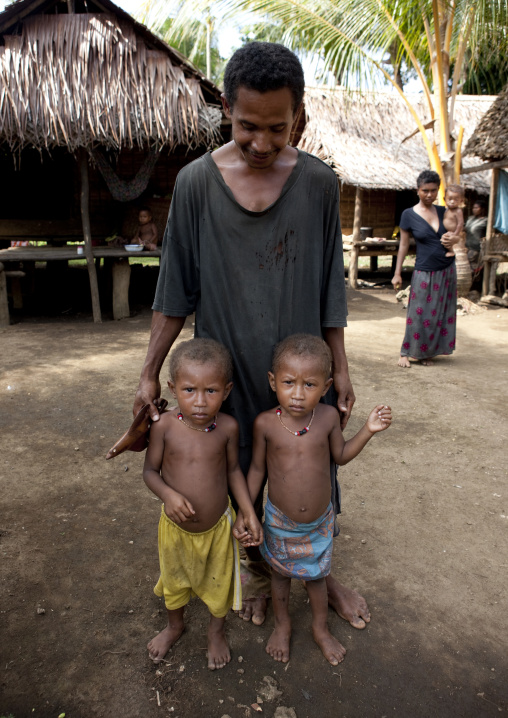 Mother with her twin boys, Milne Bay Province, Trobriand Island, Papua New Guinea