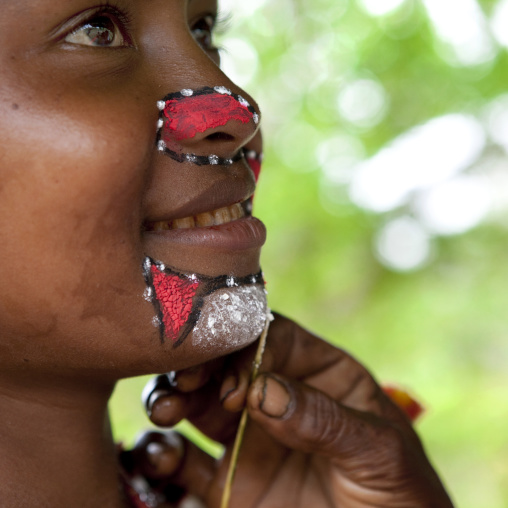 Tribal woman makeup before a ceremony, Milne Bay Province, Trobriand Island, Papua New Guinea